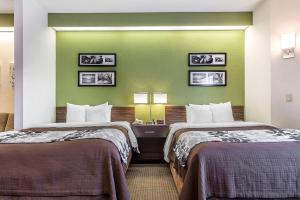 two beds in a hotel room with green walls at Sleep Inn & Suites North Augusta in North Augusta +28 photos