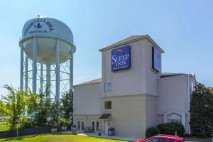 a building with a water tower in the background at Sleep Inn & Suites North Augusta in North Augusta