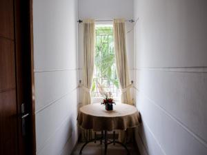 a small table in a room with a window at RedDoorz near Kebun Raya Bogor 2 in Bogor
