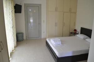 a bedroom with a bed and a door to a closet at Av Apartment in Agios Nikitas