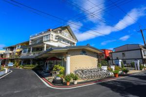 a building with benches in front of a street at Avica Homestay in Wujie