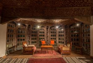 a stage with chairs and a table and lights at Serena Khaplu Palace in Khaplu