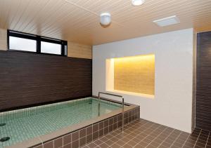 a swimming pool in a building with a pool at Shibetsu Grand Hotel in Shibetsu City