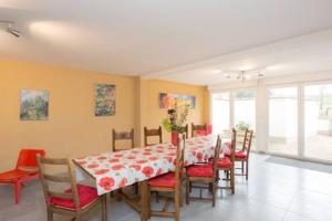 a dining room with a table and chairs and a table and chairsktop at Les Coquelicots in Marieulles