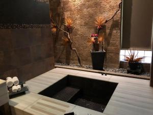 a bathroom with a bath tub with plants in it at Idee SPA Motel in Yangmei