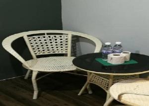 a table and a chair with two bottles of water at Lucky Hotel in Sungai Petani