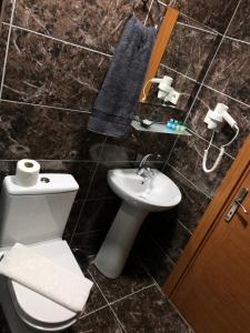 a bathroom with a toilet and a sink at Ottoman's Pearl Hotel in Istanbul