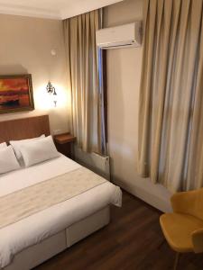 a hotel room with a bed and a window at Ottoman's Pearl Hotel in Istanbul