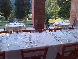 a dining room table set with chairs and tables at Agriturismo Villa Buoninsegna in Rapolano Terme