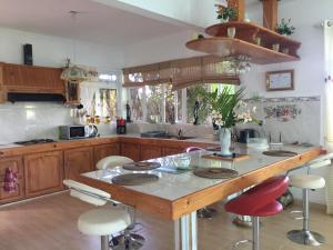 a kitchen with a island with bar stools at Panorama Villa in La Gaulette