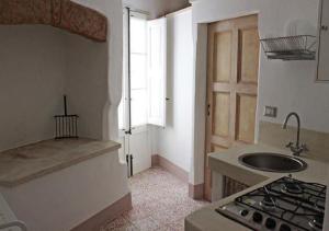 una cucina con lavandino e piano cottura di Casetta di paese a Matino