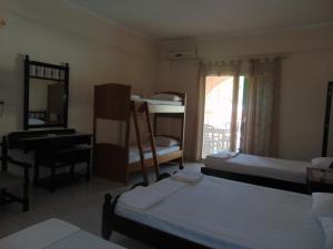 a room with several bunk beds and a window at Villa Magdalena studios in Ágios Ioánnis +68 photos