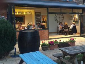 a group of people sitting at a restaurant at Plum Pudding in Abingdon