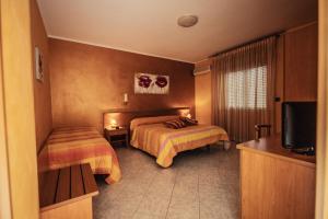 Postel nebo postele na pokoji v ubytování Hotel Venere