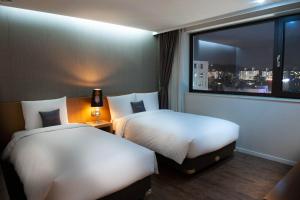 Cama ou camas em um quarto em Amanti Hotel Seoul