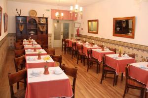 a restaurant with tables and chairs with red tablecloths at Residencial Carvalho in Estremoz