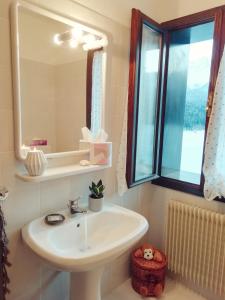 a bathroom with a sink and a mirror at Elison-on the lake B&B in Sauris