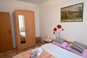 een slaapkamer met een bed en een vaas met bloemen bij Apartment Adriana in Rovinj