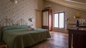 Postel nebo postele na pokoji v ubytování Villa Cornarea