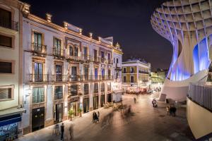 a group of buildings in a city at night at Intelier Casa de Indias in Seville
