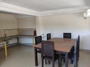 a dining room with a table and chairs at M3 Homes in Munnar +70 photos