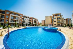 a large swimming pool in front of some apartment buildings at Waterpark Fort Apartments in Sunny Beach
