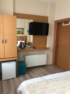 a room with a bedroom with a bed and a kitchen at Ottoman's Pearl Hotel in Istanbul