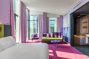 a bedroom with a bed and a living room at Room Mate Bruno, Rotterdam in Rotterdam +66 photos