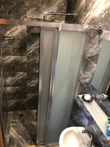 a bathroom with a stainless steel shower with a sink at Ottoman's Pearl Hotel in Istanbul