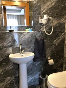 a bathroom with a sink and a mirror and a toilet at Ottoman's Pearl Hotel in Istanbul