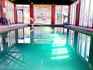 an empty swimming pool in a building with windows at Main Lead Ballarat Motel in Ballarat