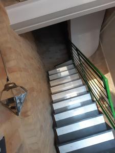 a spiral staircase in a house with a ceiling at DormidaNoi in Civitanova Marche