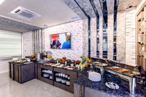 a restaurant with a buffet line with food at Parallel Hotel in Baku