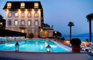 a large swimming pool in front of a building at Hotel Ghiffa in Ghiffa