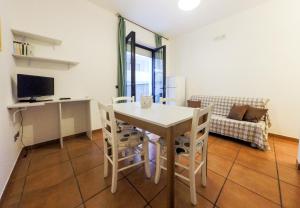 un soggiorno con tavolo, sedie e divano di BlueBay Apartment Gallipolitravel a Gallipoli