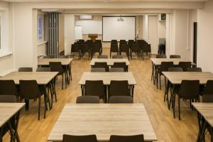 a classroom with tables and chairs and a whiteboard at MKM Hotel in Moscow