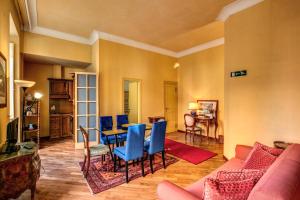 a living room with a table and blue chairs at Charming Suite by the Vatican sx in Rome