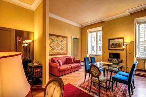 a living room with a red couch and a table at Charming Suite by the Vatican sx in Rome