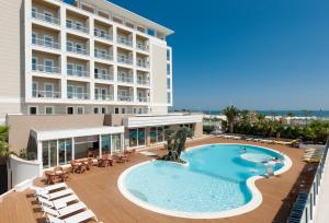 an image of a hotel with a swimming pool at Hotel Ambasciatori in Riccione