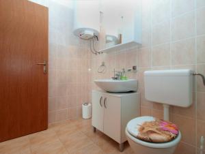 a bathroom with a toilet and a sink at Apartments Mira 1804 in Medulin