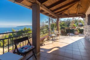 a patio with a view of the ocean from a house at The Terrace in Mošćenice