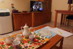 a table with a tray of tea cups and a table sidx sidx sidx at Apartamento Tres Carretas Puerto Real in Puerto Real