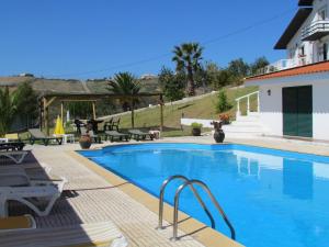 a swimming pool in front of a house at Quinta Do Forno in Vimeiro