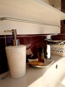 a kitchen counter with a soap dispenser and a plate of food at Quarantadue Quindici in Termoli