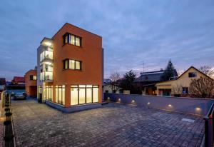 a large brick building with lights on the side of it at Ratkajec Luxury Apartments in Varaždin