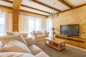 a living room with a couch and a flat screen tv at DeLuxe Villa Suza in Kras