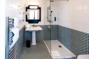 a bathroom with a sink and a shower at Best Western Hôtel Journel Antibes Juan-les-Pins in Antibes