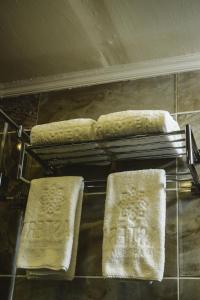 three towels on a rack in a bathroom at Eastern Al Montazah Hotel in Alexandria