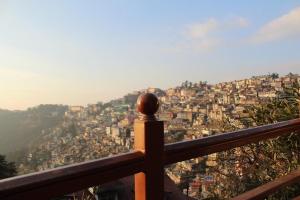 a view of a city from a balcony at The Hill Crest Inn in Shimla