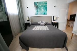 a bedroom with a large bed with a black blanket at Residenza L'isola - Il Chiostro by Dimorra in Naples